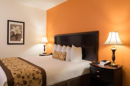 a hotel room with a bed and a telephone at Oakland Airport Executive Hotel in Oakland
