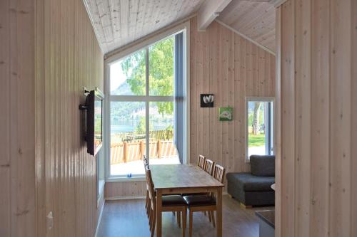 a dining room with a table and a window at Kinsarvik Camping in Kinsarvik