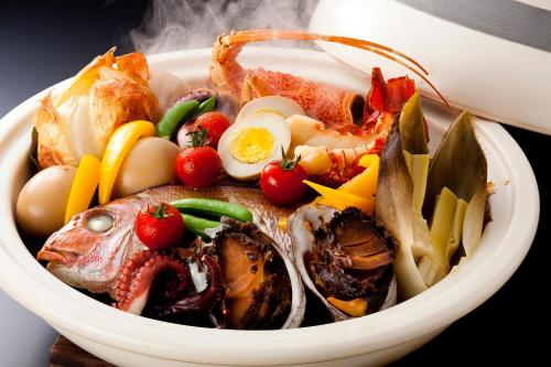 a bowl of food with eggs and vegetables on a table at Hanagoyomi in Sumoto