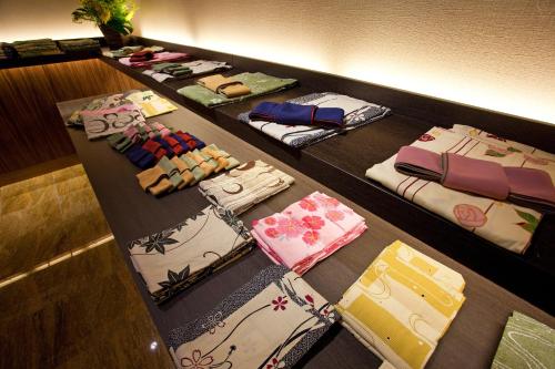 a row of ties are lined up on a shelf at Hanagoyomi in Sumoto