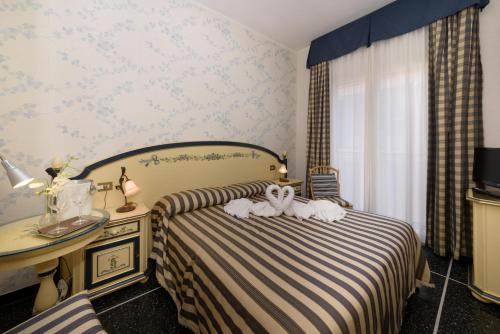 Postel nebo postele na pokoji v ubytování Hotel Morchio Mhotelsgroup