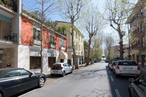 a street with cars parked on the side of the road at Hotel Morchio Mhotelsgroup in Diano Marina