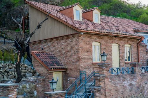 a brick house with a red roof at Citadel Express in Tbilisi City