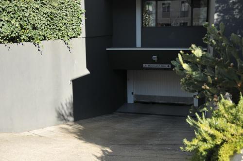 a house with a black door and some plants at Privilège Hôtel & Apparts Eurociel Centre Comédie in Montpellier