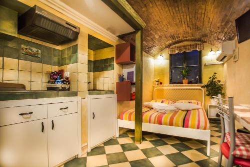 a kitchen with a bed in the middle of a room at Cosy Little Love Nest in Piran in Piran