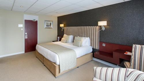 a bedroom with a large bed in a hotel room at The Barnstaple Hotel in Barnstaple