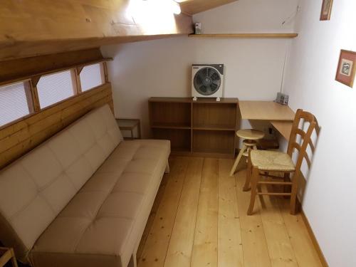 a room with a bed and a desk with a fan at Agriturismo Collelungo di Maremma in Diaccialone