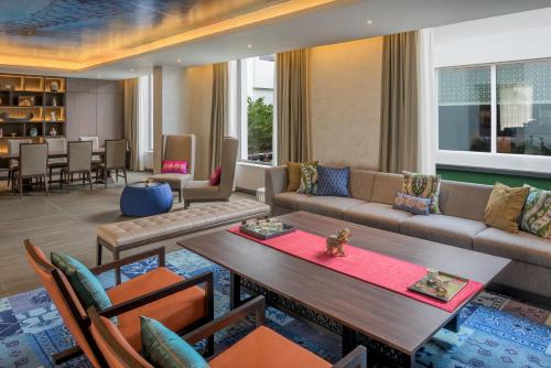 a living room with a couch and a table at The Residency Towers, Rameswaram in Rāmeswaram
