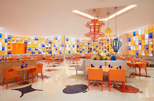 a restaurant with tables and chairs and colorful tiles at Wynn Palace in Macau