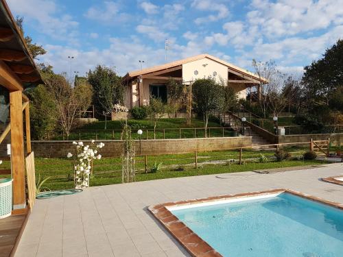 a house with a swimming pool in a yard at Agriturismo Collelungo di Maremma in Diaccialone
