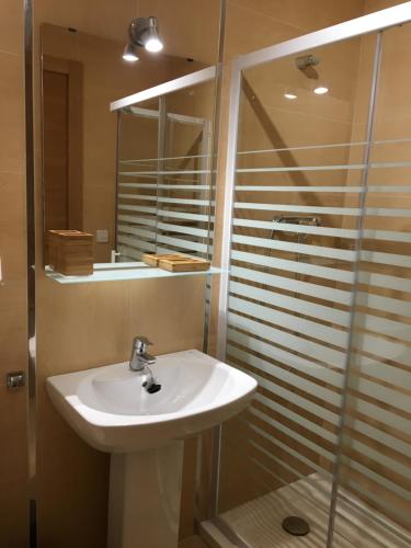 y baño con lavabo y ducha. en Apartament Vall d'Àger, en Àger