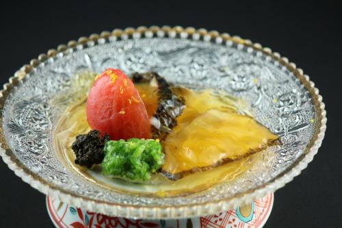 a glass bowl filled with fruit and vegetables on a table at Shorenkan Yoshinoya in Kyotango