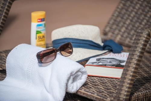 a stuffed animal wearing sunglasses on a table with a towel at Parkhotel Muldental in Colditz