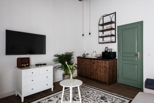 a living room with a tv and a table at R40 Vendégház in Mád