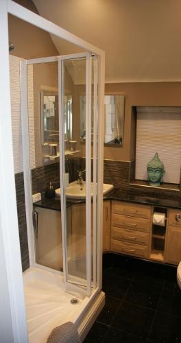 a bathroom with a shower and a sink at The Old Dairy Malvern in Great Malvern