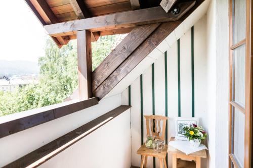 a room with a window and a table with flowers at Salzburg Hotel Holznerwirt in Eugendorf