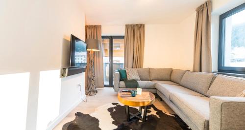 a living room with a couch and a table at Kristall Plaza in Niederau