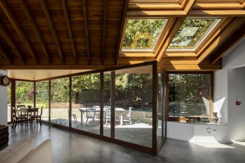 an open living room with large windows and a patio at Quinta da Tilia Boutique Retreat in Capelas