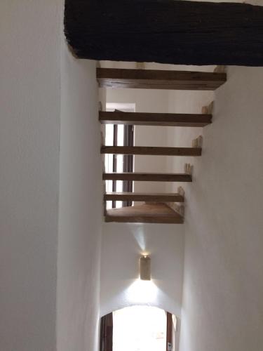 a room with a wooden ceiling with a window at La casa del geko in Vieste
