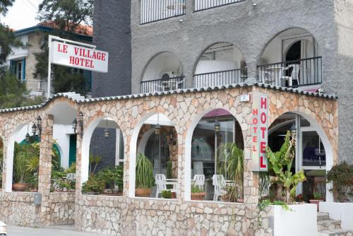 a building with a stone facade with a restaurant at Le Village Hotel in Limassol