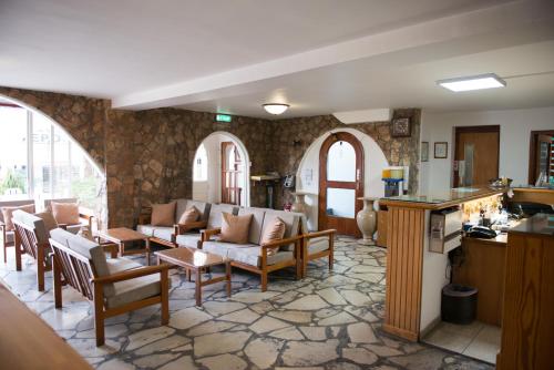 a living room with chairs and a table at Le Village Hotel in Limassol