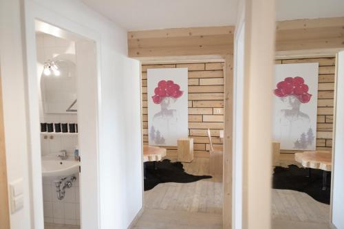 a bathroom with two mirrors and a sink at Kuckucksnester Feldberg in Feldberg