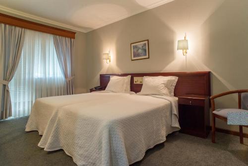 Giường trong phòng chung tại Hotel Boavista II