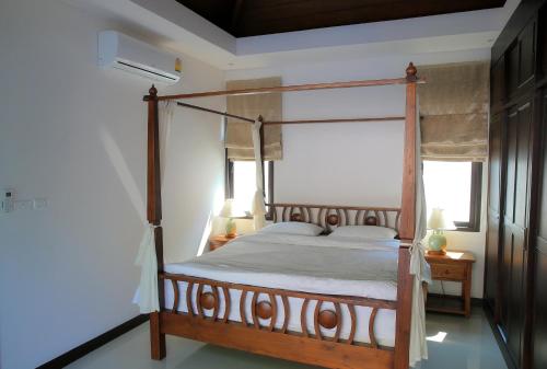 Tempat tidur dalam kamar di Naiharn Beach Villa