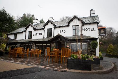 a restaurant with tables and chairs in front of a building at The Queen's Head Hotel in Troutbeck