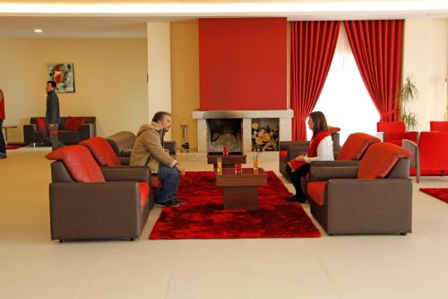 a group of people sitting in a waiting room at Palace Hotel & SPA Termas do Bicanho in Soure