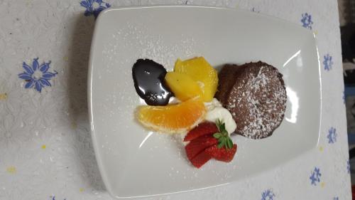 a white plate with some desserts on it at Locanda Milano 1873 in Brunate