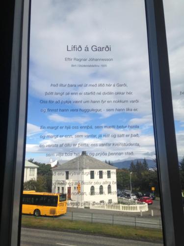 a window with a picture of a bus and a building at Student Hostel in Reykjavík