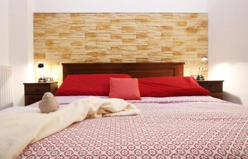 a bedroom with a large bed with red pillows at L'Angolo in Orta San Giulio