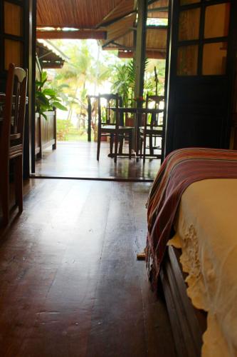 a bedroom with a bed and a table and chairs at Hotel Gerard et Francine in Ambatoloaka