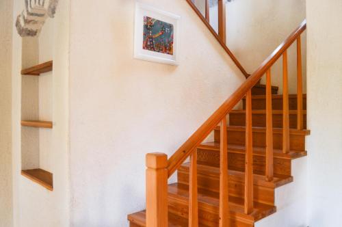 a wooden staircase with a painting on the wall at Villa Mandarin by Important Group Travel in Bitez