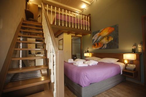 a bedroom with a purple bed and a staircase at 11City Rooms in Chania Town