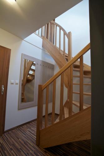 a wooden staircase in a room with a mirror at Pútnický mlyn in Marianka