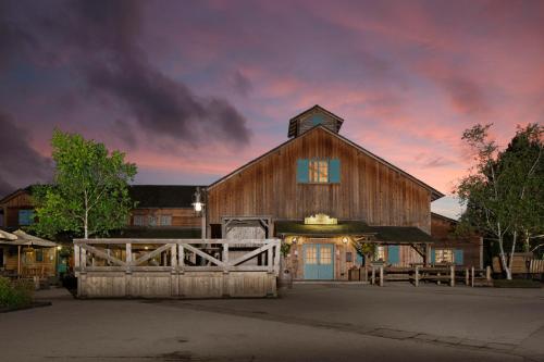 a large barn with a fence in front of it at Disney Davy Crockett Ranch in Villeneuve-le-Comte