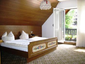 a bedroom with a large bed and a large window at Landhaus im Grund in Lennestadt