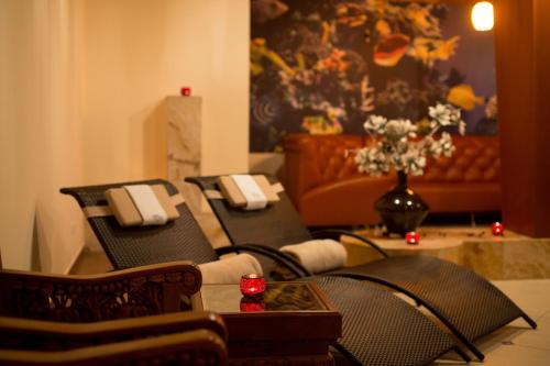 a living room with black chairs and a couch at SPA Amber Palace in Šventoji
