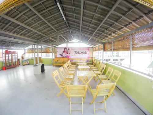 a row of tables and chairs in a cafeteria at Hoa Sua Hotel in Vung Tau