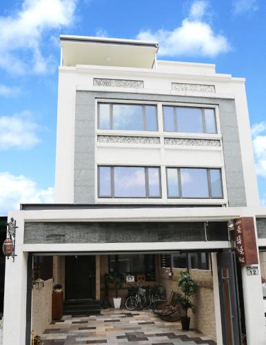 a white building with windows and bikes in front of it at Aria 2 Home (With Elevator) in Hualien City