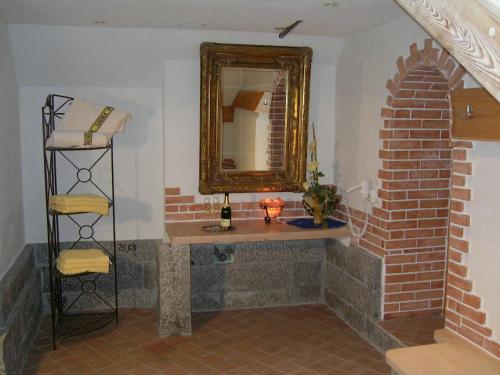 a bathroom with a sink and a mirror at Ferienhof Kampfl in Fügen