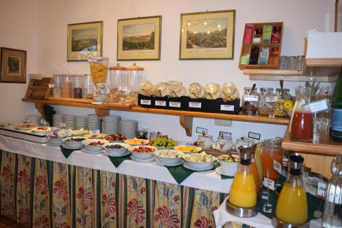 a buffet with plates of food on a table at Hotel Landhaus Fuhrgassl-Huber in Vienna
