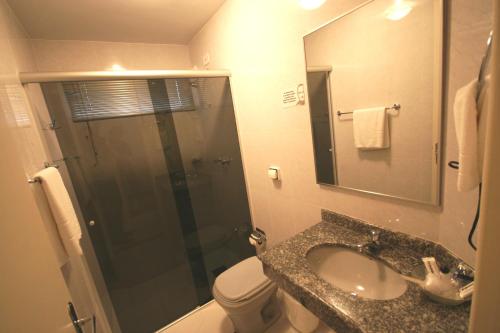 a bathroom with a shower and a sink and a toilet at Patriarca Hotel in Itapeva