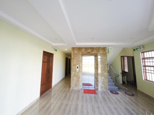 a room with a hallway with a door and stairs at Hoa Sua Hotel in Vung Tau