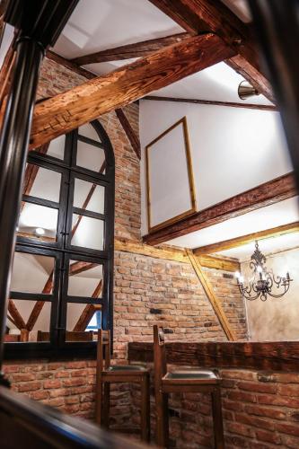 a dining room with a brick wall and a window at Casa Crown in Braşov