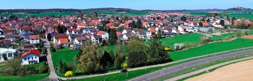 an aerial view of a village with houses and a road at Hotel Zur Krone in Ronneburg
