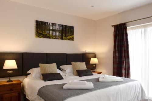a bedroom with two beds with towels on them at The Red Lion, Barn Accommodation in Thornby