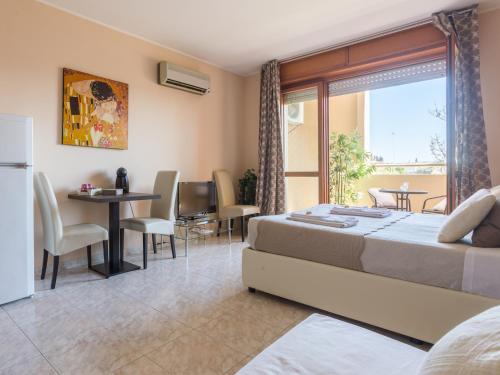 a bedroom with a bed and a table and chairs at Residenze Su Planu in Cagliari